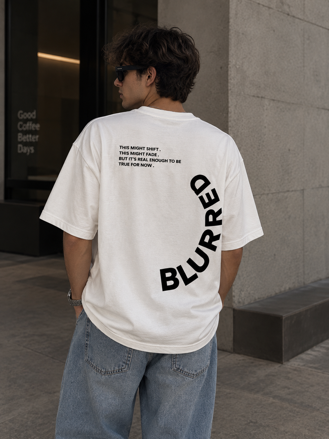 Back view of white Blurred oversized graphic tee with black typography
