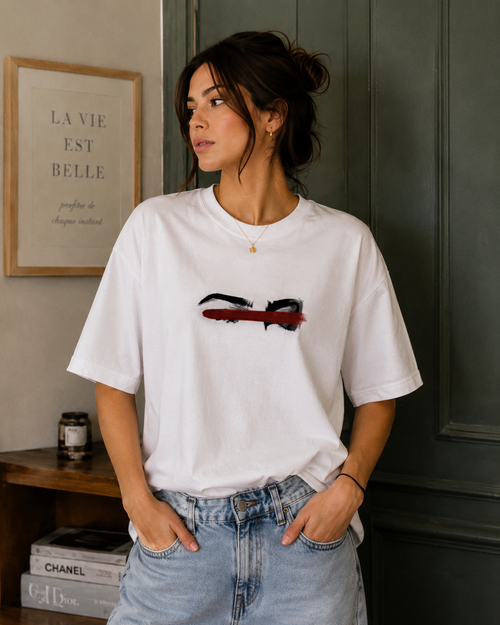 Front view of model wearing Queenly Eyes Never Lie white regular-fit graphic T-shirt